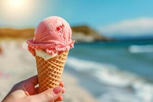 Raspberry ice cream cone on beach photo