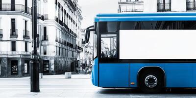 Blue city bus parked on a street in an urban area during daylight hours photo