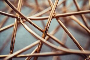 Intricate golden wires create an abstract design showcasing modern art at an indoor exhibition photo