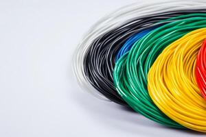 Colorful electrical wires arranged in a circular pattern on a white background suitable for various projects photo