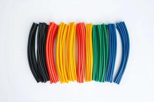 Colorful flexible tubes arranged symmetrically on a white background illustrating creativity and design photo