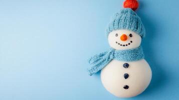 Colorful handmade winter snowman craft displayed against a light blue background with creative details for festive cheer photo