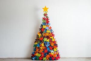 Colorful jigsaw puzzle tree with a star on top stands cheerfully against a white wall, adding a festive touch to the decoration photo