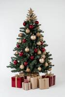 A beautifully decorated Christmas tree with red and gold ornaments and wrapped gifts under it, set against a white background photo