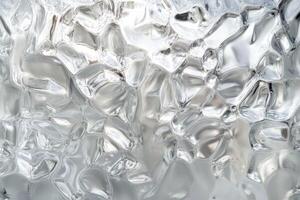 Textured frosted glass with a unique wavy pattern reflecting light in a soft, ambient setting, perfect for artistic backgrounds or decor photo
