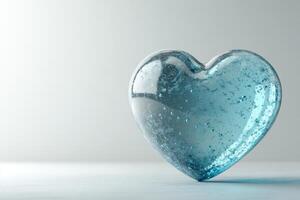 A glossy blue heart resting gently on a soft light gray background, showcasing its captivating color and delicate texture in a serene setting photo