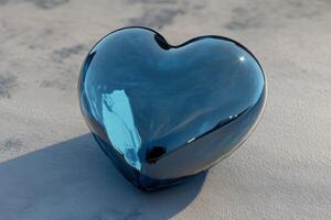 A glossy blue heart resting peacefully on a soft light gray background, reflecting subtle hues of brightness photo