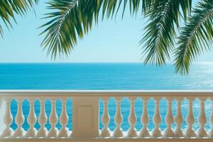 Relaxing balcony view of the tranquil sea and lush palm trees at a luxury hotel during a sunny afternoon photo