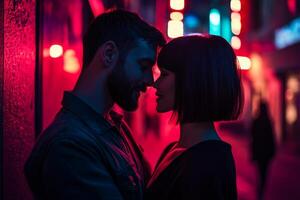 A joyful couple embraces in a dark urban street illuminated by neon lights at night photo