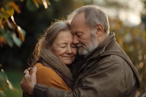 Elderly couple embraces in a warm garden during autumn morning light, conveying love and tranquility while dressed in casual attire photo