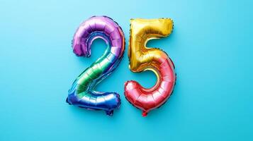 Colorful rainbow foil balloon in the shape of number twenty-five on a bright blue background, perfect for celebrations photo