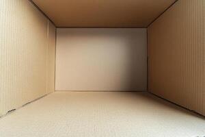 Minimalist cardboard box with blank surface on white background for product mockup in studio lighting photo