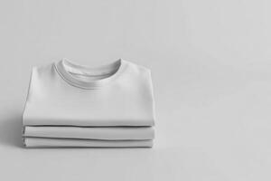 Neatly folded white t-shirt on a plain background with studio lighting in a minimalist setting for clothing mockup photo