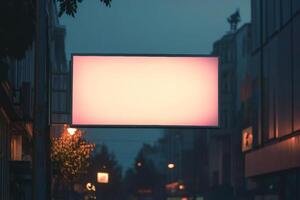 Evening city lights illuminate a blank billboard on a building facade with a soft background blur photo