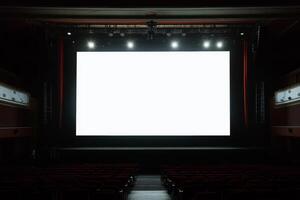 Blank screen on a concert hall stage during an event, illuminated by bright lights against a dark background photo