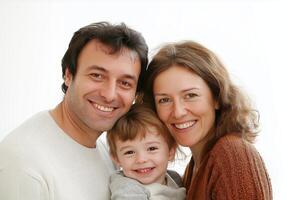 A cheerful family portrait with parents and young child smiling against a minimalistic white background photo