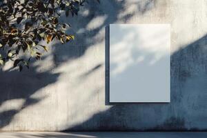 Empty poster on a concrete wall illuminated by sunlight, creating soft shadows and a minimalist backdrop for artistic expression photo