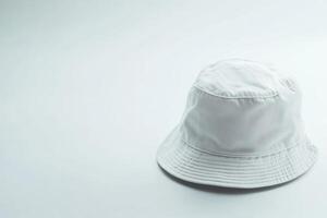 A simple white bucket hat rests on a clean white background, showcasing a minimalist design ideal for summer activities or casual outings photo