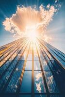 Modern high-rise glass building reflecting sunlight and surrounding structures in an urban landscape during bright daytime hours photo
