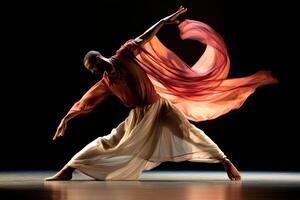 Contemporary dancer gracefully expressing movement in an artistic performance with flowing outfit and dramatic lighting photo