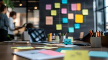 A diverse business team collaborates on ideas in a modern office with laptops and notes scattered on the table during a brainstorming session photo