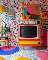 Vintage 1980s room featuring retro television, cassette player, and vibrant patterned wallpaper with nostalgic decor elements photo