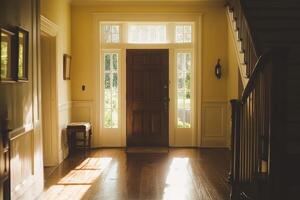 Bright and welcoming entry hall illuminated by sunlight with a cozy atmosphere and wooden elements photo