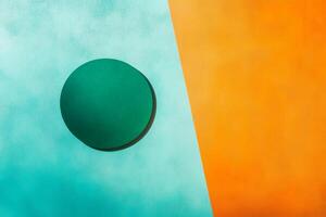 Minimalist green circle set on a vibrant blue and orange split background creating a striking visual contrast photo
