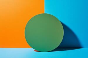 Minimalist composition featuring a green circle on a vibrant blue and orange split background photo