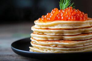 Stack of fluffy pancakes topped with vibrant salmon roe for a gourmet breakfast experience photo