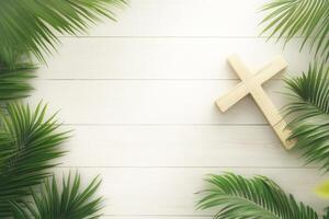 A wooden cross surrounded by palm leaves on a white wooden background reflecting Christian faith during Holy Week photo