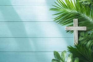 Wooden cross with palm leaves on a white wooden background for Ash Wednesday and Palm Sunday reflections in the Holy Week season photo
