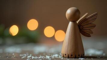 Wooden angel figurine stands gracefully on a table with a soft glowing background during a festive season celebration photo
