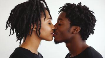 A loving black couple shares a tender kiss, showcasing their deep romantic connection against a simple white background photo