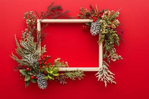 Creative Christmas frame adorned with festive greenery and red accents for holiday invitations and postcards photo