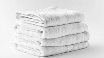 A neatly folded set of clean white towels isolated on a bright white background showcasing their softness and cleanliness for bathroom use photo