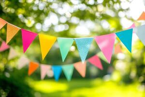 Colorful bunting flags strung across trees at a joyful outdoor celebration on a sunny day photo