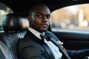African American billionaire dressed in formal attire, sitting in a limousine while enjoying a luxurious journey photo