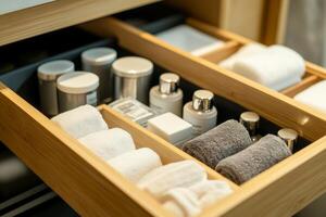 Elegant bathroom drawer organized with luxury toiletries and neatly folded towels, showcasing a clean and orderly lifestyle photo