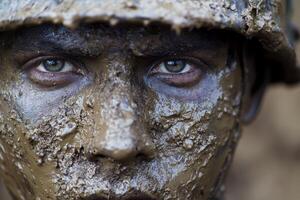 A soldier with a muddy face during training exercises in a forest environment in the early morning light photo
