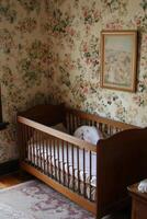 Cozy nursery featuring a wooden crib and charming floral wallpaper in a peaceful corner of the home photo