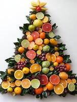 Handcrafted citrus Christmas tree wall decoration made with fresh fruits and foliage for a festive holiday display photo
