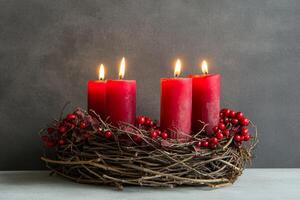 Natural Advent wreath with four burning red candles for Christmas celebration in France photo