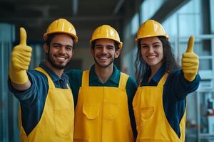 Diverse team of janitors in safety gear proudly giving thumbs up in a modern facility during daylight hours photo