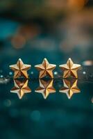 Five gold stars reflecting on a polished surface, symbolizing excellence and luxury in a serene setting photo