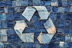 Recycling logo crafted from upcycled denim showcases sustainable artistry using old jeans in a creative textile project photo