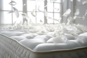 Swirling white feathers dance above a plush mattress, creating an ethereal atmosphere in a softly lit room photo