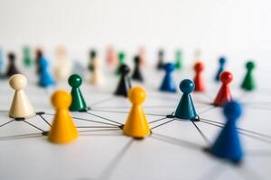 Colorful game pieces connect in an abstract representation of social networking and relationships on a white surface photo
