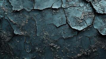 Cracked blue wall texture revealing an aged and weathered surface with dark hues and rough patches photo