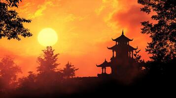 Silhouette of an Indian temple against a vibrant sunset sky with dramatic colors and empty space for text above photo